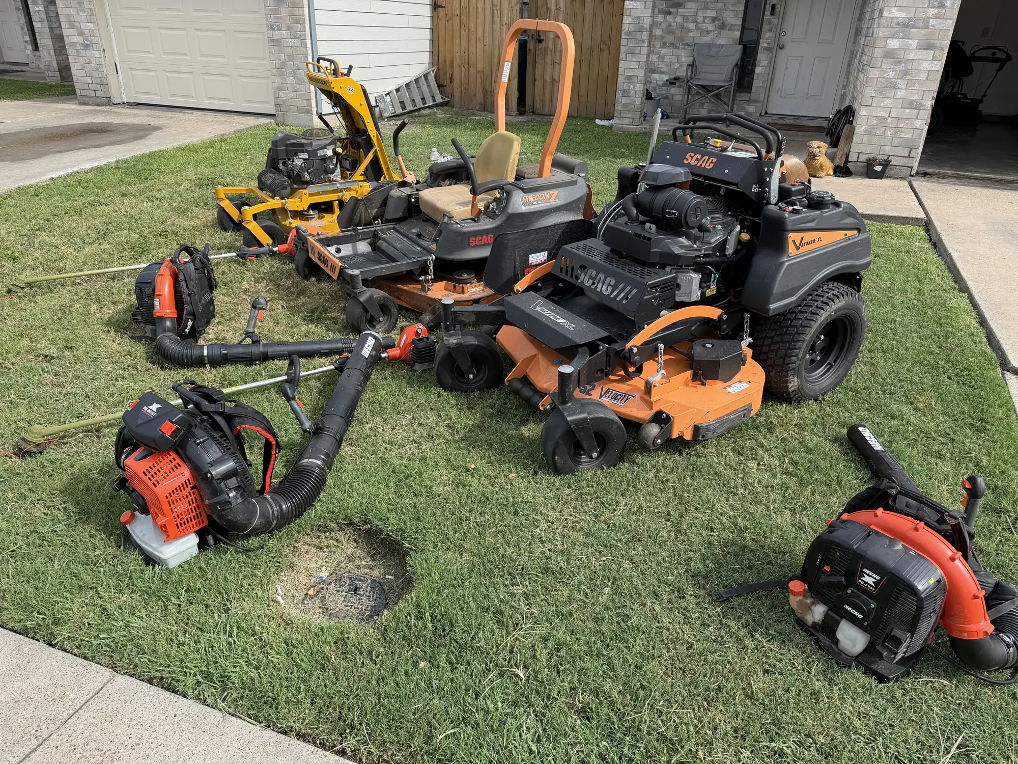 LRT's commercial mowers, blowers and trimmers staged on a finished lawn